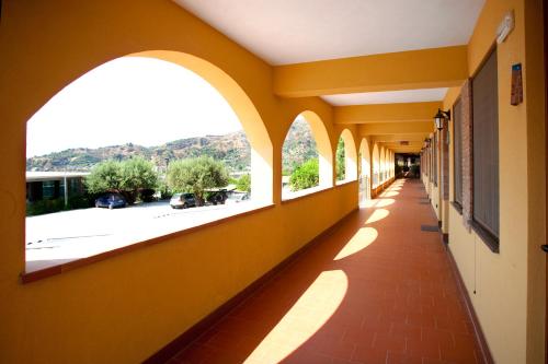 an empty hallway of a building with arched windows at 'A Nuciara Park Hotel & Spa in Furci Siculo