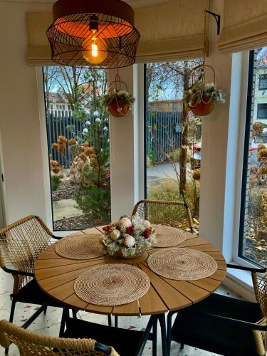 a wooden table with flowers on it in a room at Salt Garden Superior double rooms in Druskininkai