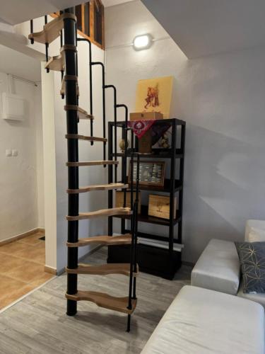 a spiral staircase in a room with a bed at White Party House in Veľké Kosihy