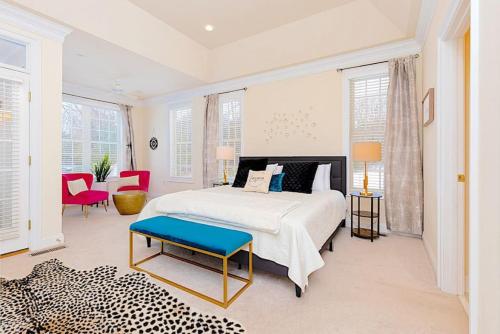 a white bedroom with a bed and a blue bench at Stoney Creek Cottage Minutes to Wintergreen in Nellysford