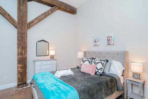 a bedroom with a large bed and a mirror at Breakfast at Tiffanys Downtown Newport News in Hampton