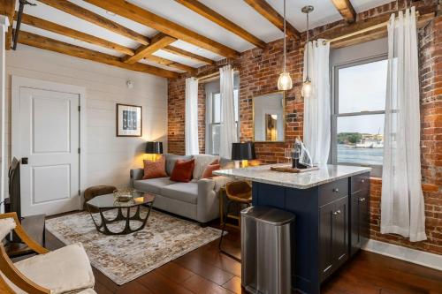 a living room with a brick wall at Tugboat Vista 2 Bedroom Downtown Portsmouth in Portsmouth