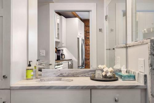 a white kitchen with a sink and a counter at Tugboat Vista 2 Bedroom Downtown Portsmouth in Portsmouth