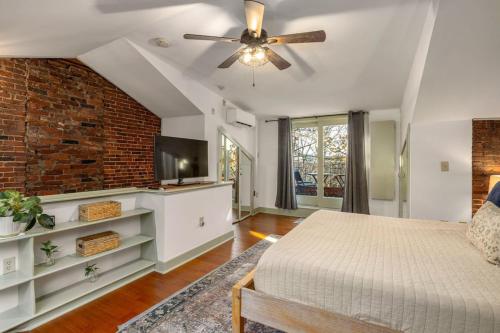 a bedroom with a bed and a ceiling fan at City Loft Group Getaway King Downtown Location in Newburyport
