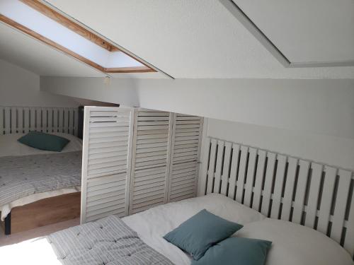 - une chambre avec 2 lits jumeaux et une lucarne dans l'établissement Capbreton - Villa Patio - Climatisé - Port - Surf, à Capbreton