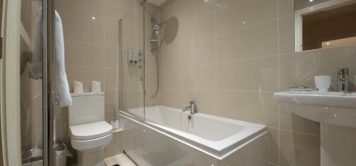 a white bathroom with a toilet and a sink at Modern Apartment 5 at Christchurch Park in Ipswich