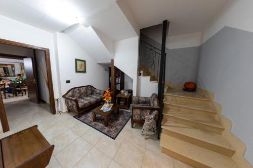 a living room with a staircase and a stair case at River Hotel in Castel di Sangro