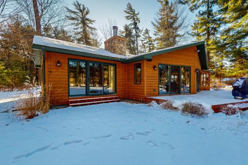 a wooden house in the snow in the yard at Seasons Pass in Eagle River
