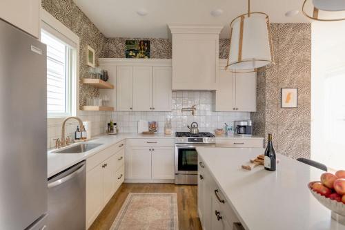 a kitchen with white cabinets and a sink at The Lyric - New Luxury Home, Rooftop with Firepit! in Nashville