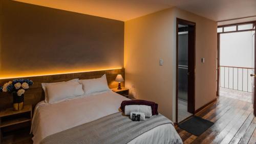 a bedroom with a large bed and a balcony at Hotel Catedral Boutique Loft in Pasto