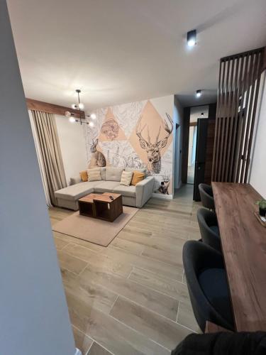 a living room with a couch and a painting on the wall at Villa Mont in Jahorina