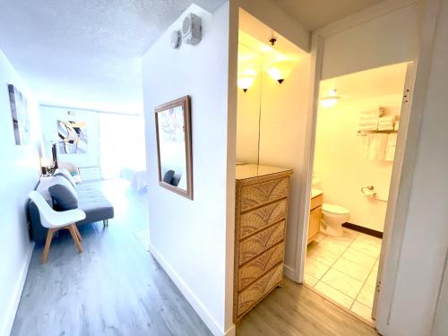 a bathroom with a vanity and a chair and a mirror at Marine Surf 20FL Free Parking Renovated - Cal King in Honolulu