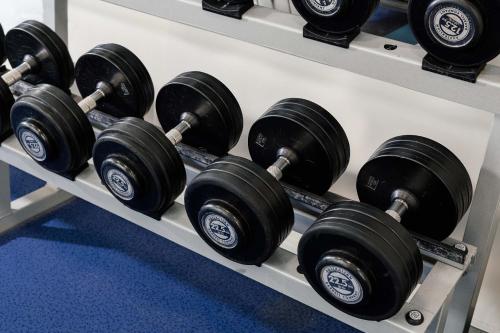 a row of black dumbbells on a shelf at Mantra Lorne in Lorne