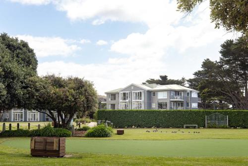 a large apartment building with a park in front of it at Mantra Lorne in Lorne