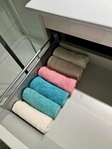 a row of towels in a drawer in a bathroom at Sea Light Seaview Vista Mar Apartment - Luz, Lagos in Luz