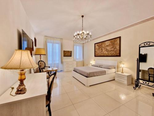 a bedroom with a bed and a table with a lamp at Anime Sante Apartment - Piazza Duomo in LʼAquila
