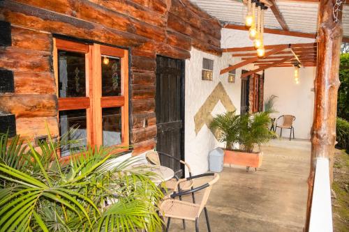 an outside view of a wooden house with plants at Riverside La Masía Ecohotel in Quindío