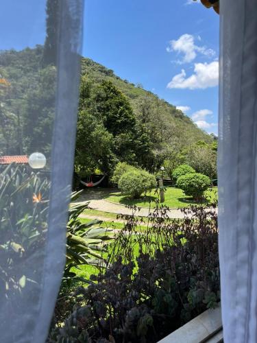 a view of a garden from a window at Recanto dos Vianas in Teresópolis
