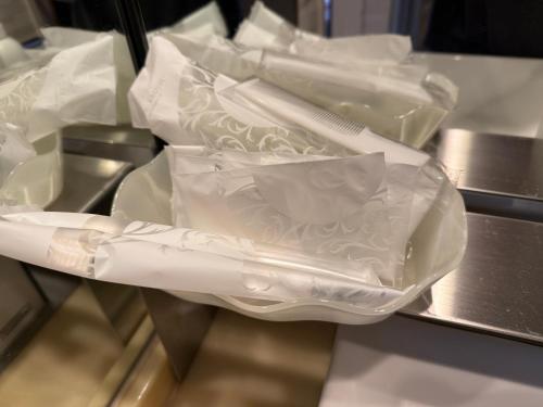 a group of white plastic bags on a conveyor belt at ホテルホワイトシティ23Adults only in Tokyo