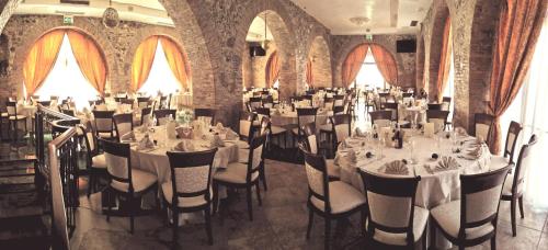 a banquet room with tables and chairs and windows at Relais Il Mulino in Corigliano Calabro