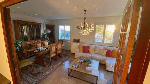 a living room with a couch and a table at Casa Lovo in Saint-Laurent-de-Mure