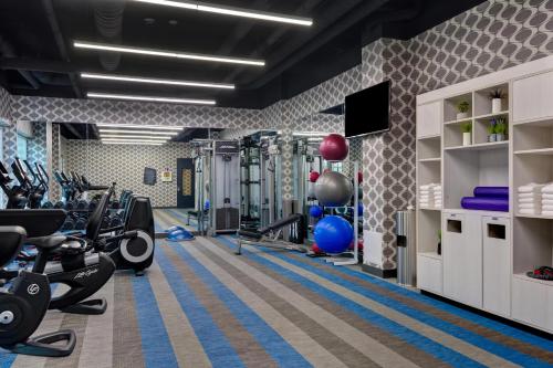 a gym with treadmills and cardio equipment in a room at Aloft Secaucus Meadowlands in Secaucus