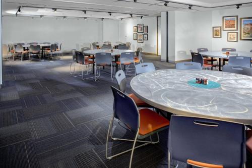 a conference room with tables and chairs and a large table at Aloft El Paso Downtown in El Paso