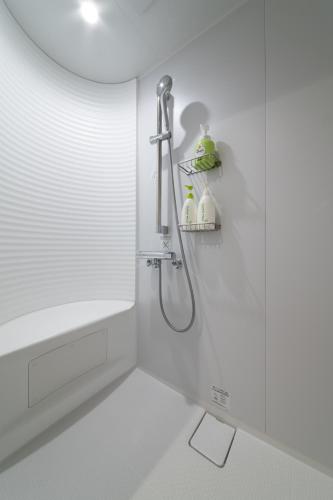 a bathroom with a shower with a shower head at Niseko Highland Cottages in Niseko