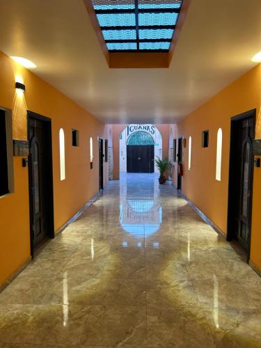a hallway with a pool in the middle of a building at Tres Iguanas Apart Hotel - New, cozy & spacious flats, short walk to beach in Loreto