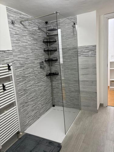 a shower with a glass door in a bathroom at La casa di Canneto in Genova