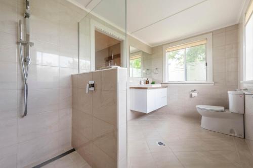 a bathroom with a shower and a toilet and a sink at Clarence River Retreat - Oceanstays - Farmstay & Jetty in Lawrence