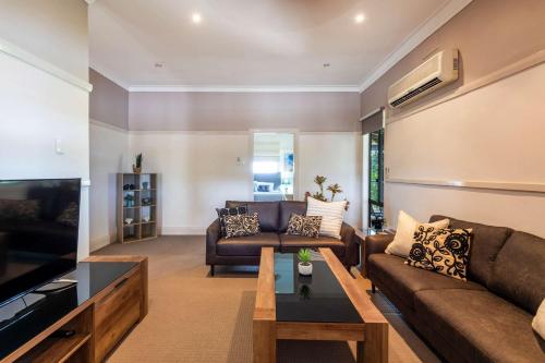 a living room with a couch and a table at Clarence River Retreat - Oceanstays - Farmstay & Jetty in Lawrence