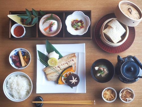 a plate of food with sushi and rice on a table at 森のオーベルジュ 三 みつ - 旧 森厚真hotel CHUPKI - in Chitose