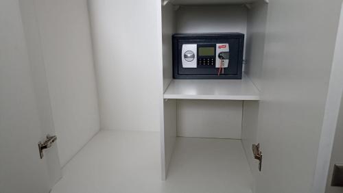 a small cabinet with a clock in a bathroom at Departamento Condominio Parque Pucón in Pucón