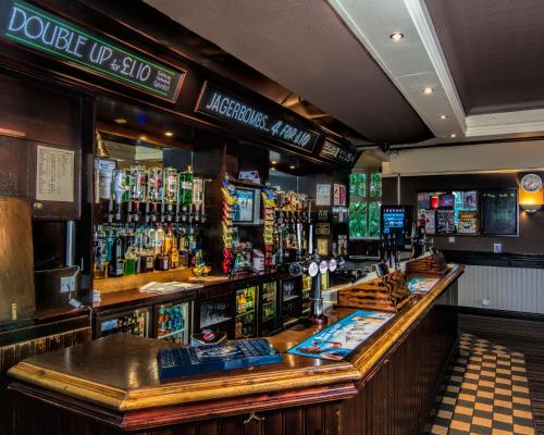 a bar in a pub with a lot of alcohol at The Miners Arms in Leeds