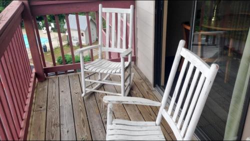 Dos mecedoras blancas sentadas en un porche en Days Inn by Wyndham Waynesville NC en Waynesville