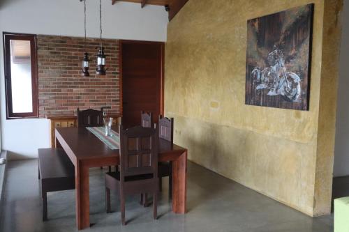 a dining room with a wooden table and chairs at Mount Bliss Home Stay in Mount Lavinia