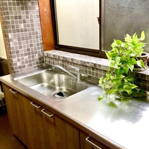 a kitchen sink with a potted plant on it at #熱海古民家 #来宮神社 バーベキュー温泉 in Atami