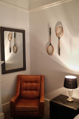 a living room with a chair and a mirror at Manly Waves Studios & Apartments in Sydney