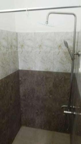 a bathroom with a shower with a glass door at The Coral in Port Louis