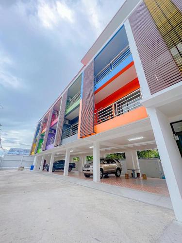 a building with a car parked in front of it at J & Ariya Hotel Near Samui Airport and Koh Phangan Pier in Bophut 