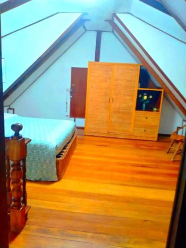 a attic room with a bed and a dresser at Chalet Leam Sor in Laem Sor