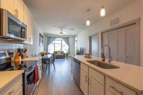 a kitchen with a sink and a counter top at Top Floor City Views! King Bed Pool Gym Free Parking in San Antonio