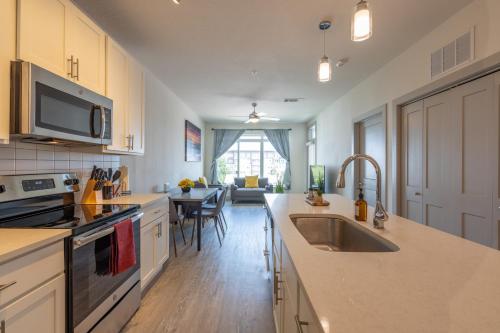 a kitchen with a sink and a counter top at Top Floor City Views! King Bed Pool Gym Free Parking in San Antonio