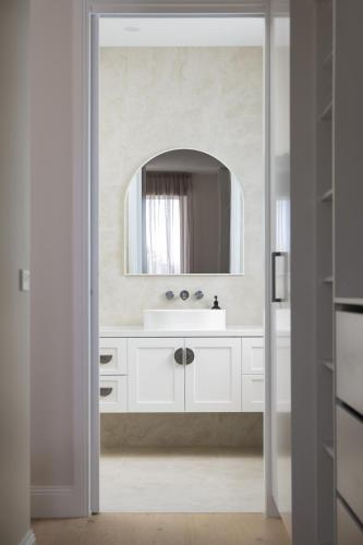 a bathroom with a white sink and a mirror at Rosewood Retreat New luxury Home in Rosebud