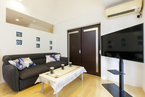 a living room with a couch and a table at -華 HANA- Vacation Rental in Nagoya