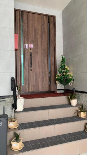 a lobby with a door with a christmas tree on it at 楽Home in Otaru