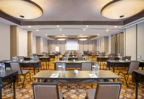 a large dining room with tables and chairs at Swiss-Belhotel Airport Yogyakarta in Yogyakarta