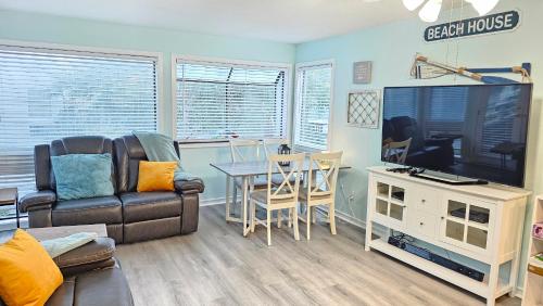 a living room with a couch and a tv and a table at 2BR/2BA Condo at Arcadian Dunes Building 10-238 in Myrtle Beach