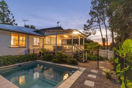 a house with a swimming pool in front of it at Rambling Roses in Witta